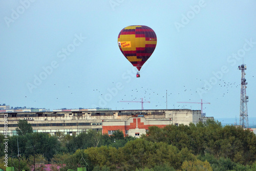  Nizhny Novgorod, Russia, 08.19.2021A colored balloon in the sky over the city. Close-up, isolated. © Ольга Кожина