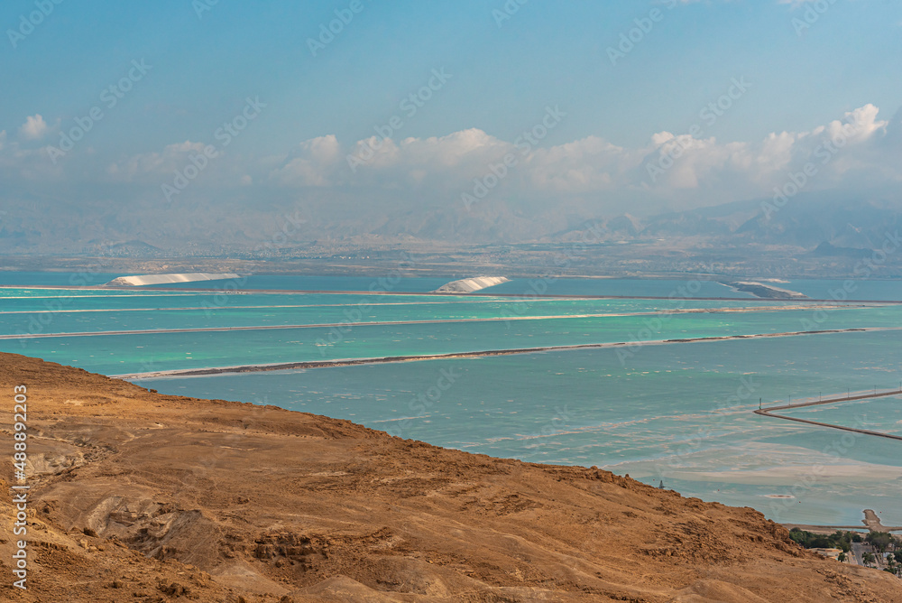 View of the desert mountains and the Dead Sea from an official viewpoint above the Dead Sea in Israel.
