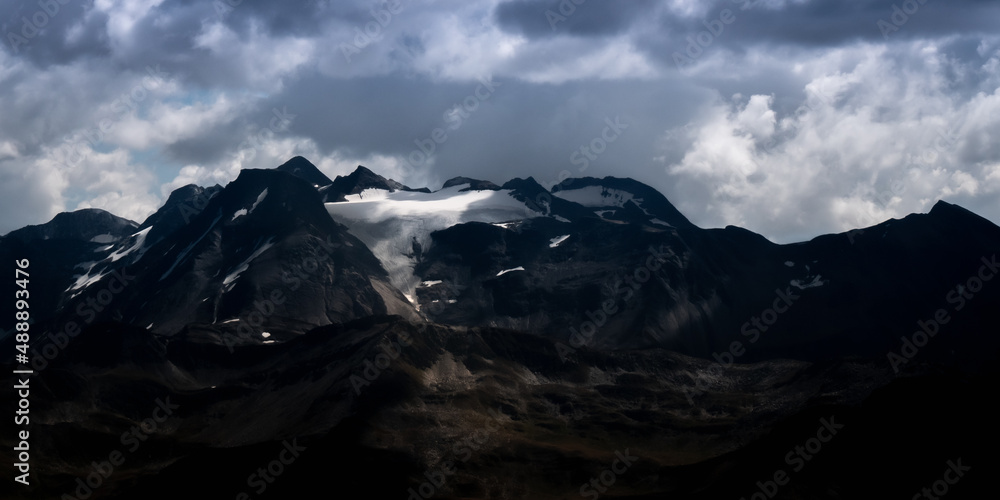 Mountain landsape in stormy weather, with a glacier on top