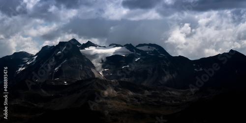 Mountain landsape in stormy weather, with a glacier on top