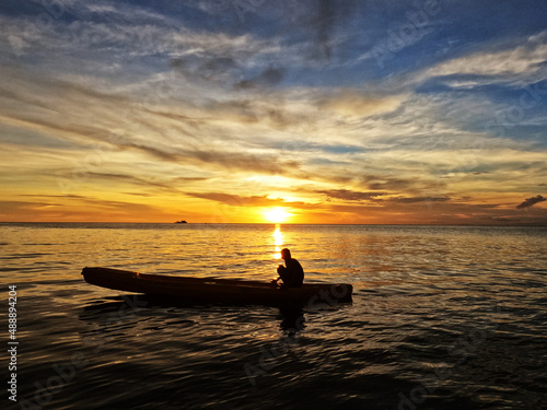Silhouette of young men on Kayak