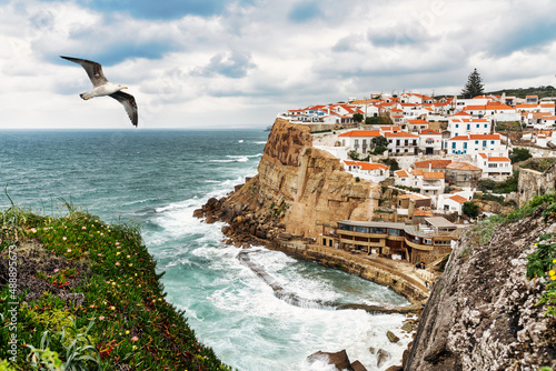 seagull flying over the typical fishing village of Azenhas do Mar in Sintra Portugal. photo