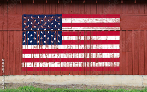red barn wall american flag painted faded worn weathered farmland heartland america symbol patriotism building photo