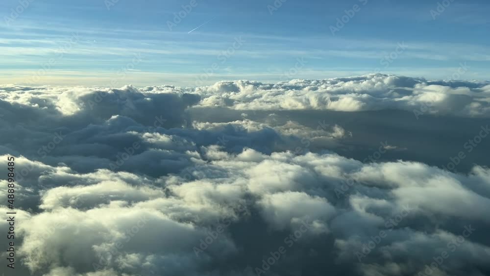Aerila view from a cockpit overflying few clouds with afernoon light Aerila view from a cockpit overflying few clouds with afernoon light