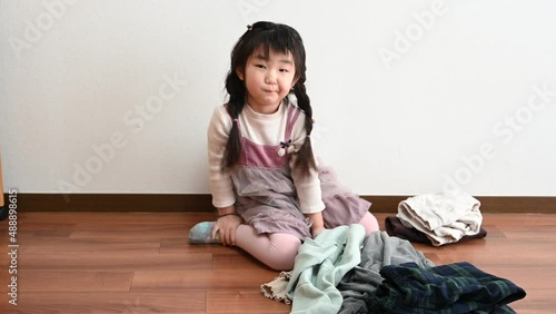 Girl helping to fold family laundry