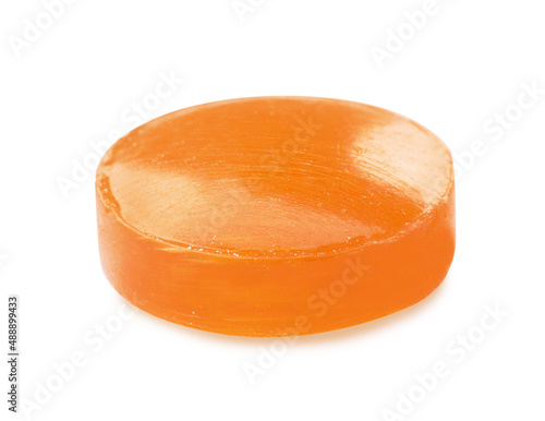One orange cough drop isolated on white