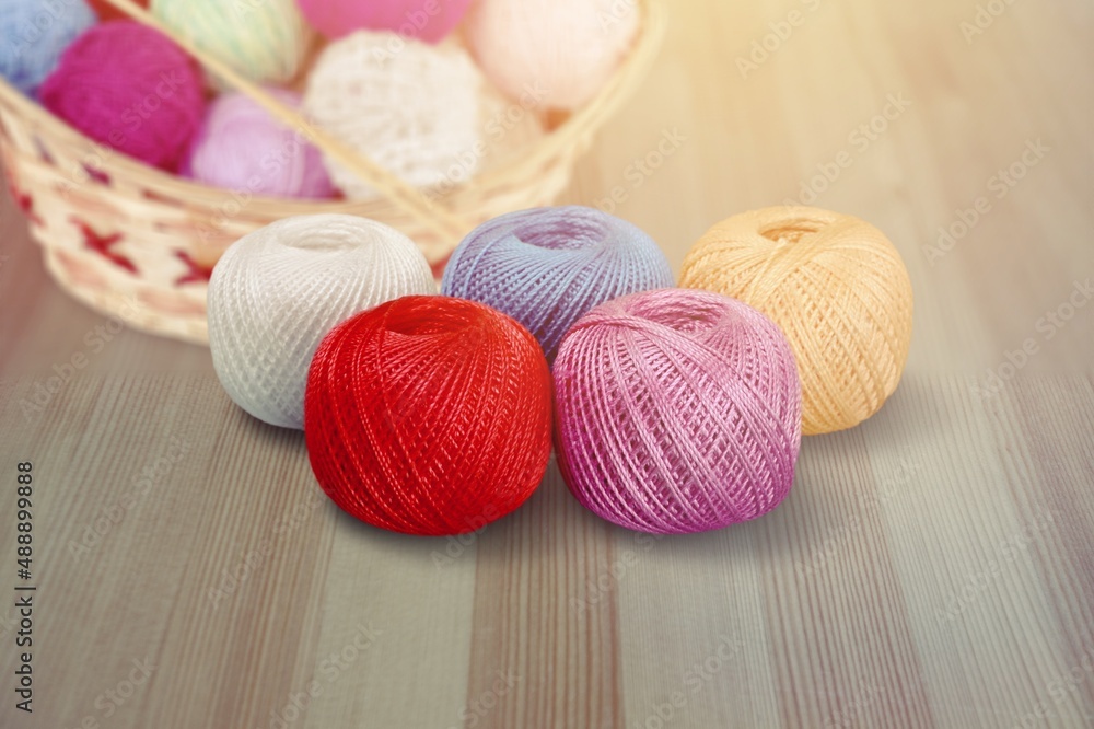 Cones of colored cotton, woolen or synthetic threads. Bobbins in textile manufacturing