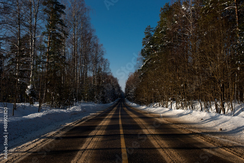 Highway road in winter forest