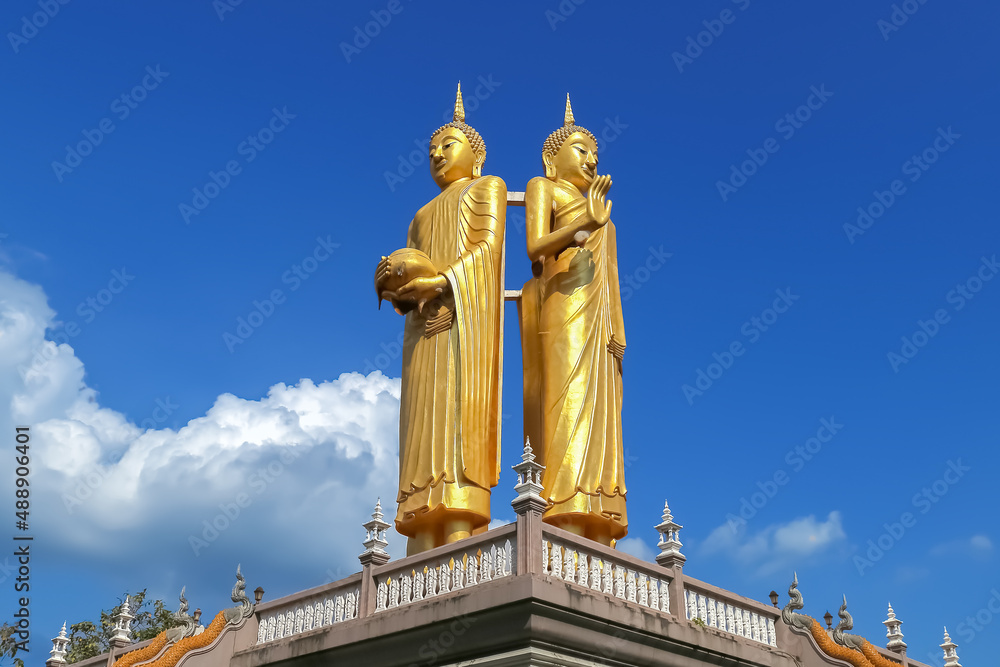 Standing Buddha statue against blue sky Standing Buddha statue against blue sky
