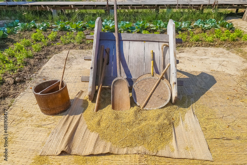 equipment threshing and separating paddy rice with a traditional style. photo