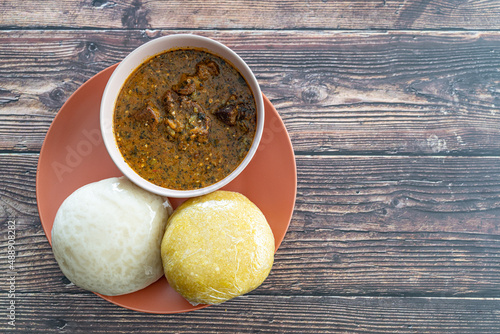 Garri and Pounded Yam served with Ogbono Soup ready to eat photo