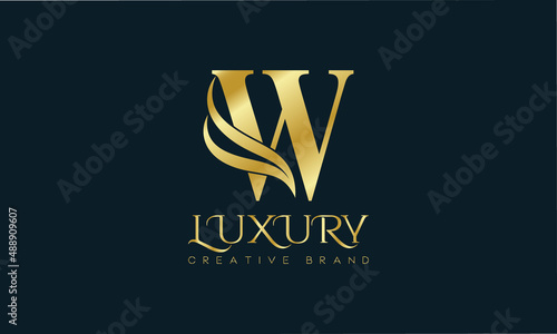 Luxury W monogram Classic Gold Lettering Typography Logo. Luxury decorative shiny vector illustration.