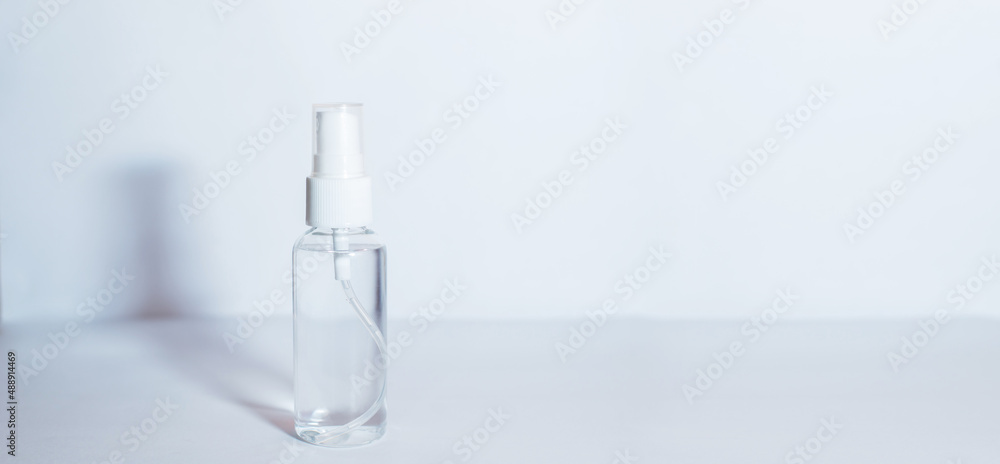 A bottle of alcohol gel is set on a white background. A bottle of alcohol gel is set on a white background.