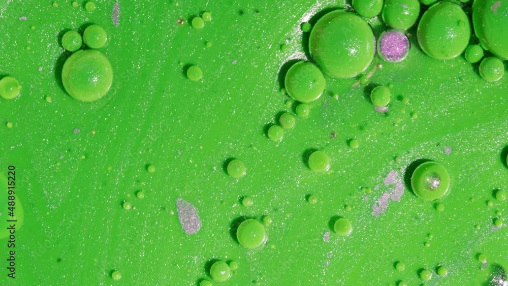 Abstract of green bubbles chaotically moves and bursts in pearl paint. Ink, pink spheres. Colorful shapes, complimentary color combination. Detailed background, design, balloons texture. Abstract of green bubbles chaotically moves and bursts in pearl paint. Ink, pink spheres. Colorful shapes, complimentary color combination. Detailed background, design, balloons texture.