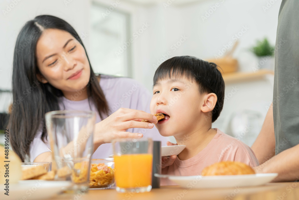 Happy refreshment family breakfast in morning, asian young parent father, mother and little cute boy, child having meal in kitchen eating together at home. Cheerful, enjoy cooking people. Happy refreshment family breakfast in morning, asian young parent father, mother and little cute boy, child having meal in kitchen eating together at home. Cheerful, enjoy cooking people.