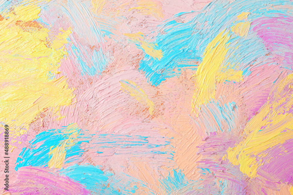 Closeup view of artist's palette with mixed pastel paints as background