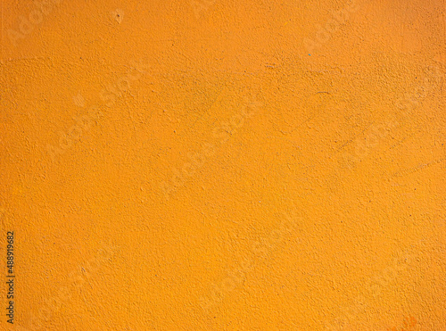 Abstract yellow cement wall texture and background. Modern grafitty wallpaper. A wall have some grunge effects and lines.