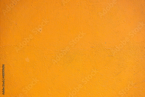 Abstract yellow cement wall texture and background. Modern grafitty wallpaper. A wall have some grunge effects and lines.