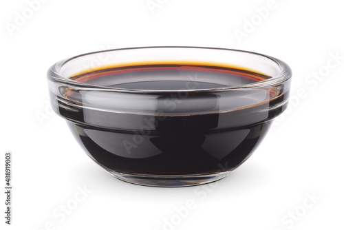 Foto Glass dip bowl with soy sauce isolated on white.