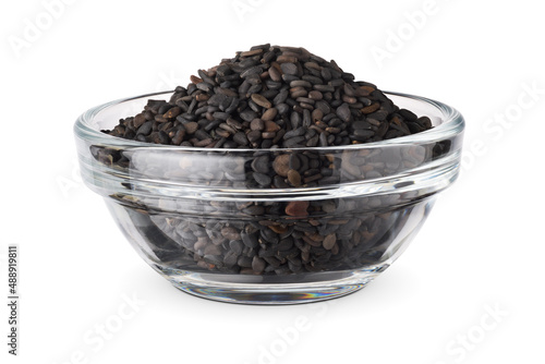 Black sesame seeds in the glass bowl isolated on white.