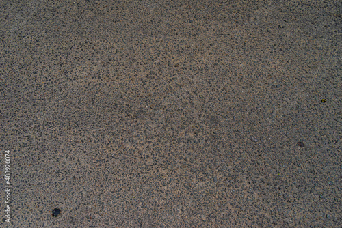 Smooth concrete real road with cracks and clutch track. Great for travel and urban purposes. Rough road texture background. Rough cracked asphalt, small gravel road