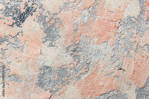 surface covered with decorative plaster with a chaotic pattern, multi-colored spots