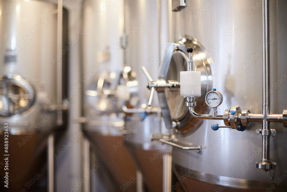Equipment for the production of craft beer, containers for fermentation in the climatic chamber, pressure gauge with tubes and stainless steel tanks.