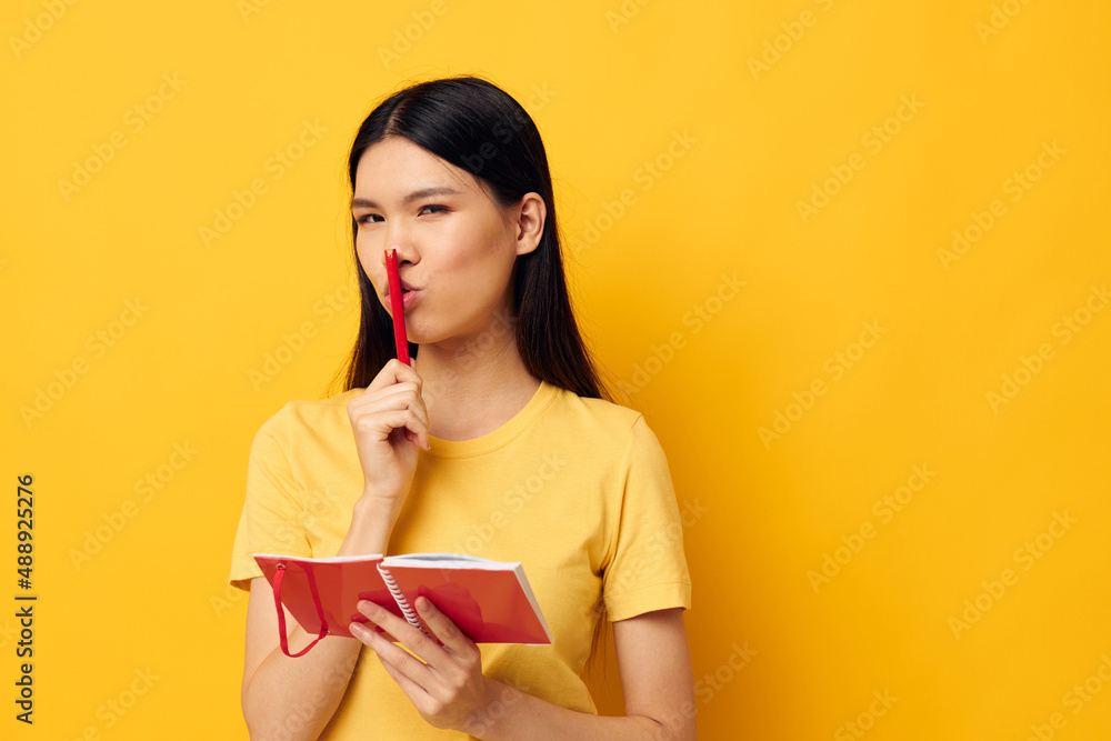 pretty brunette in a yellow t-shirt red notebook training studio model unaltered pretty brunette in a yellow t-shirt red notebook training studio model unaltered