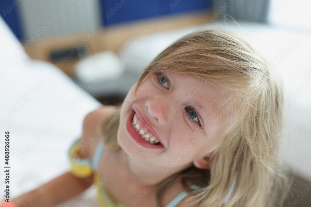Portrait of little smiling girl with tears and blond hair Portrait of little smiling girl with tears and blond hair
