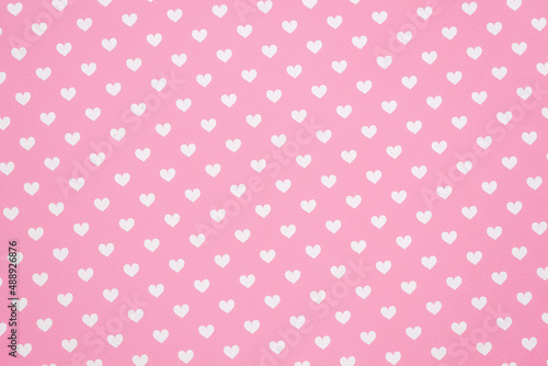 White heart pattern against a pink background.