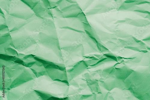 The rumpled green paper texture.