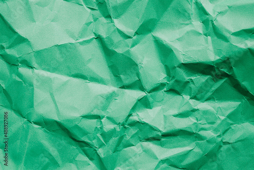 The rumpled green paper texture.