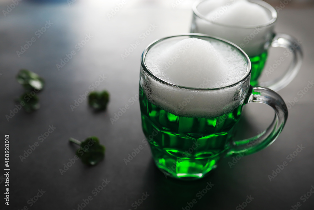 Saint Patrick's Day holiday. National Irish holiday. Green beer. Hand with a mug of emerald beer in a bar. Saint Patrick's Day holiday. National Irish holiday. Green beer. Hand with a mug of emerald beer in a bar.