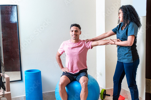 Professional physiotherapist working with female patient in rehabilitation center © IHERPHOTO