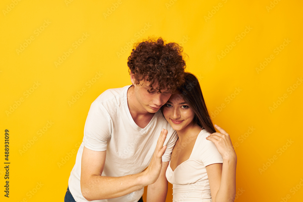 portrait of a man and a woman hug love emotion yellow background unaltered portrait of a man and a woman hug love emotion yellow background unaltered