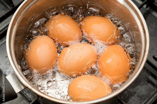 Photography Eggs being boiled in boiling water in a pot