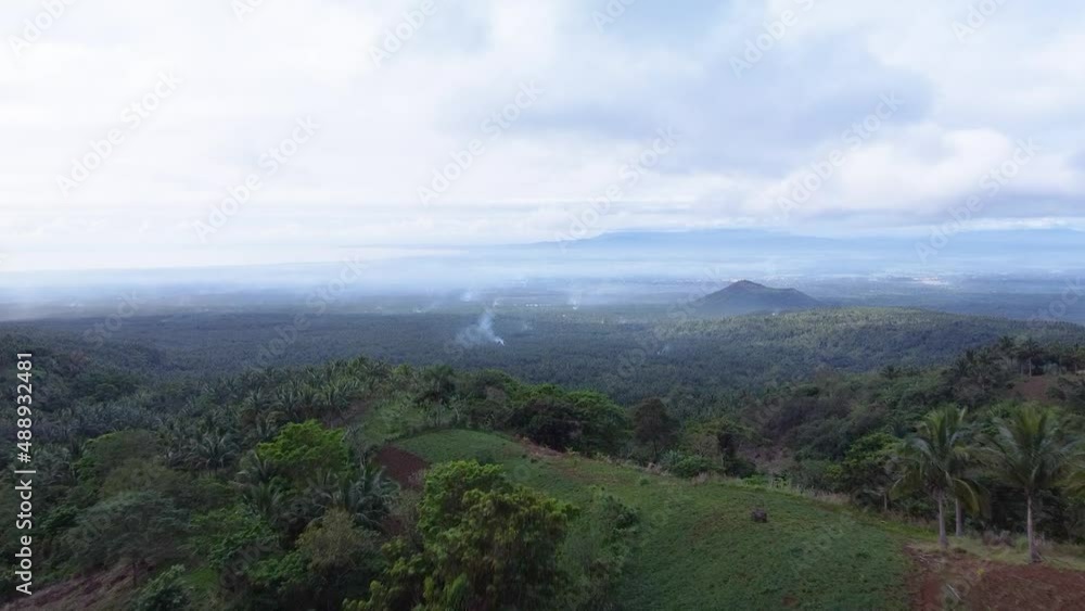 Aerial view of vast landscape with multiple mountains on the background