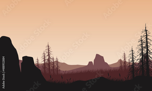 Mountain panorama with aesthetic dry tree silhouette of the countryside from the edge of the gorge at dusk