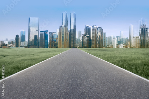 Asphalt road with modern building and skyscrapers