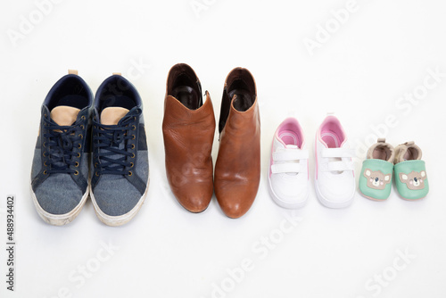 family concept parent father mother son and daughter shoes on white background