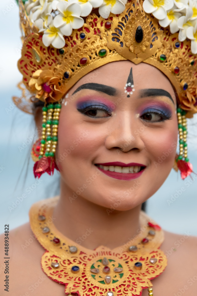 Obraz premium Portrait of beautiful young balinese woman dancer wearing a traditional costume in mountain temple.