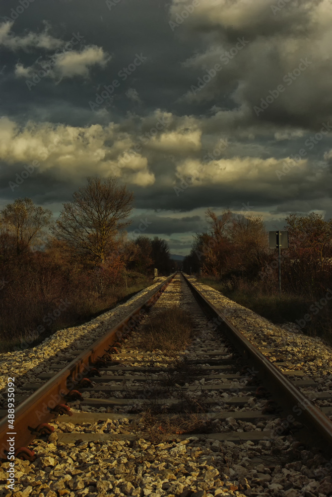 Fototapeta premium Low maintenance railway track and clouds in the sky