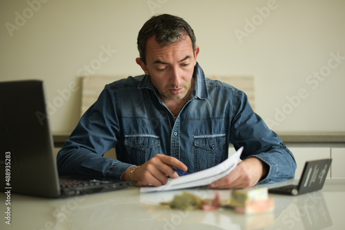 Caucasian man checking his bills photo