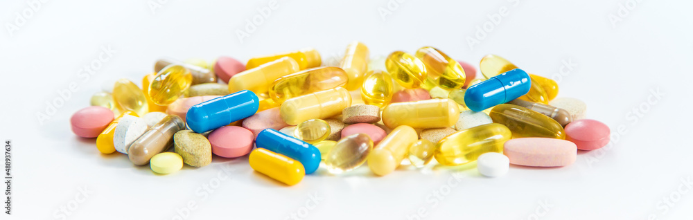 Supplements and vitamins on a white background. Selective focus. Supplements and vitamins on a white background. Selective focus.