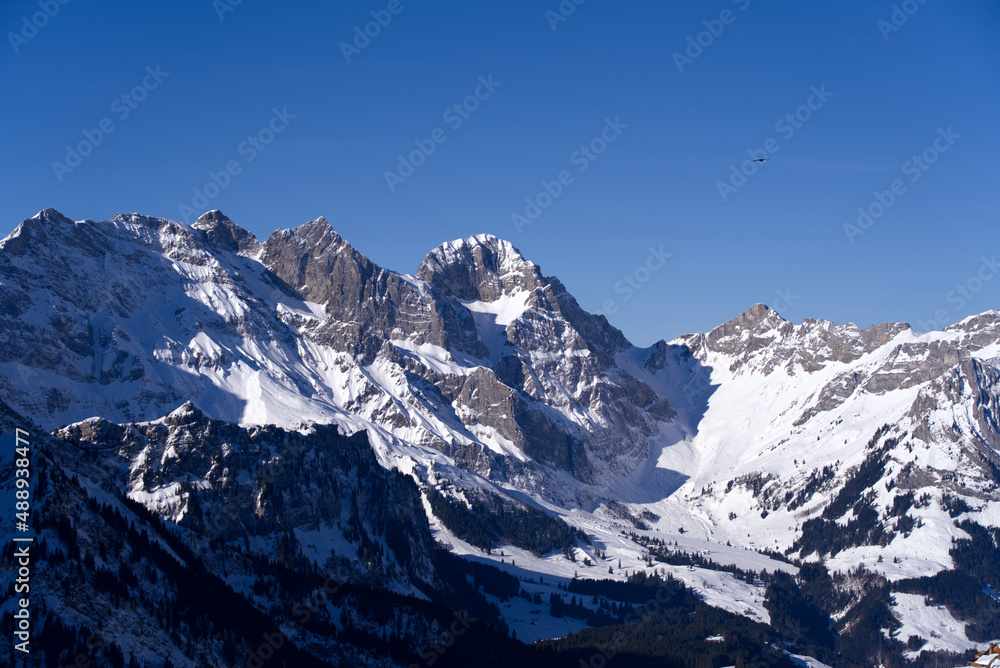 Obraz premium Aerial view of mountain panorama at the Swiss Alps seen from ski resort Engelberg, focus on background. Photo taken February 9th, 2022, Engelberg, Switzerland.