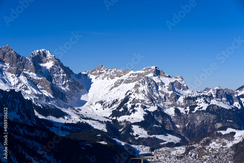 Aerial view of mountain panorama at the Swiss Alps seen from ski resort Engelberg, focus on background. Photo taken February 9th, 2022, Engelberg, Switzerland.