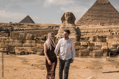Happy couple and Pyramid, Cairo, Egypt. Tourists having fun in Giza