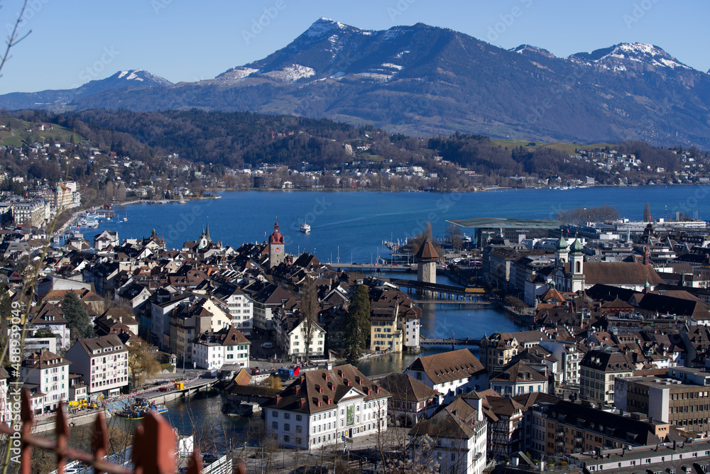 Aerial view over City of Luzern seen form local mountain Gütsch on a sunny winter day, focus on background. Photo taken February 9th, 2022, Lucerne, Switzerland.