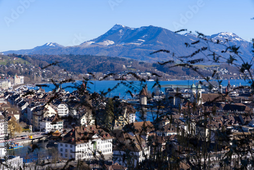 Aerial view over City of Luzern seen form local mountain Gütsch on a sunny winter day, focus on background. Photo taken February 9th, 2022, Lucerne, Switzerland. © Michael Derrer Fuchs