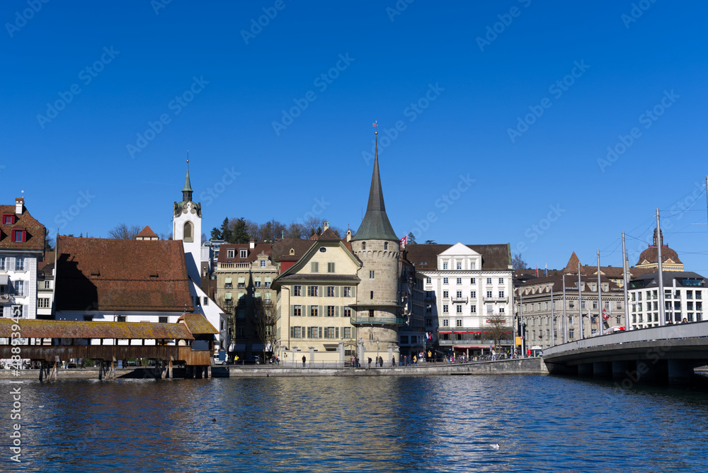 Cityscape of medieval old town of Luzern with river Reuss on a sunny winter day. Photo taken February 9th, 2022, Lucerne, Switzerland.
